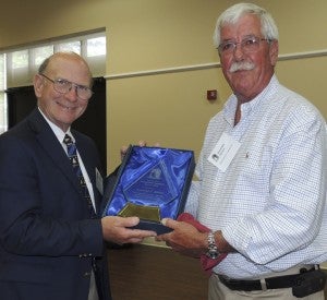 Randolph Barlow, right, president and CEO of Farmers Service in Smithfield, accepts the Grace Keen Distinguished Community Service Award during a recent meeting of the Isle of Wight-Smithfield-Windsor Chamber of Commerce.