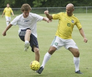 Joe Zirpolo, left, battles for possession with Brazilian missionary Claudiney Pires on Monday during a friendly exhibition game between the visiting Brazilians and Nansemond-Suffolk Academy's varsity boys' soccer team at NSA. Zirpolo, a rising senior at Virginia Wesleyan College, was one of the Saints alumni who came to help the NSA team take on the Christian missionaries from Brazil, some of which were former professional and semi-pro soccer players.