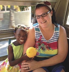 Christina Surber with Carmelie, an 8-year-old Haitian girl she met on a recent mission trip to the impoverished nation.