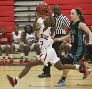 Nansemond River High School freshman point guard Tashira Burch drives to the hoop late in the fourth quarter against visiting Hickory High School on Thursday.