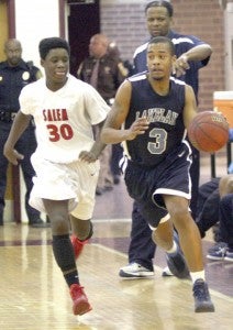 Junior Kenya Latham of Lakeland High School pushes the ball up court during the Cavaliers' 60-49 Saturday win over Salem High School.