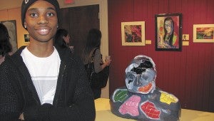 D’Antae Barrett shows off his third-place-winning work in the Suffolk Art League’s annual Exhibit of Excellence.