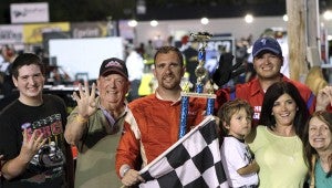 Greg Edwards celebrates with car owner James Long, along with Edwards’ wife, son and crew after his fourth win of the season, which came in the second of the twin 64-lap events for the late model stock cars class Saturday in the NASCAR Whelen All-American Series events at Langley Speedway.