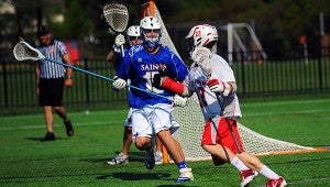 Nansemond-Suffolk Academy senior David Gough defends the goal against No. 22, and for his stellar performance on his team’s side of the field he was named Best Male Lacrosse Player in the coastal Virginia area by the Virginia Athletic Council. (Sam Mizelle photo)