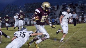 King’s Fork High School senior slotback Quadarius Boyd gains yardage under the Friday night lights, and the Bulldogs will be looking to do a lot more of that tonight on the road against Indian River High School. The Braves handed the Bulldogs one of their two regular season losses last season. (Caroline LaMagna photo)