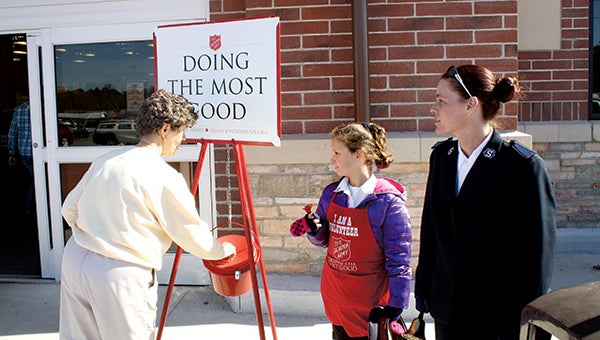 The Salvation Army's red kettle bells ring outside Kroger this holiday  season