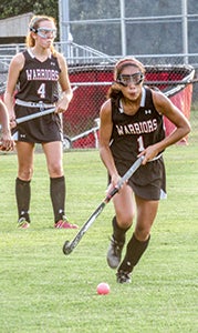 Sarah Rhiel pushing the ball up field against Conference 10 opponent Hampton High School. Lady Warriors won 7-0.