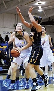 Nansemond-Suffolk Academy’s Kelly Hogan eyes the hoop against Hampton Roads Academy during a home game last year. Hogan will be one of the returning players from last year’s team. (Sam Mizelle photo)