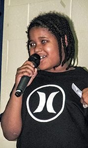 Raeqwon Boone, a student at Elephant’s Fork Elementary School, recites part of Martin Luther King’s “I have a dream” speech during a program at the school on Friday evening. 